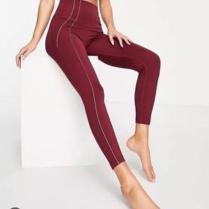 Nike Yoga Dri-FIT lurex tape 7/8 high-waisted leggings in burgundy and gold